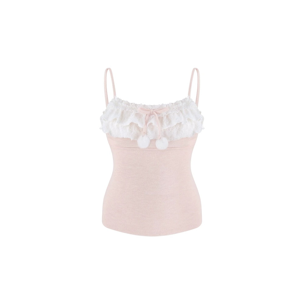 A light pink camisole top with a white ruffled lace collar, a small pink bow, and two white pom-poms, shown against a plain white background.