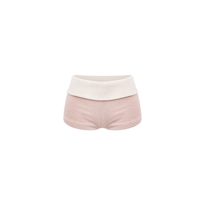 Pink shorts with a white top on a white background