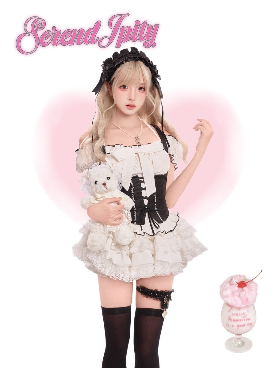 Person in a maid outfit holding a teddy bear