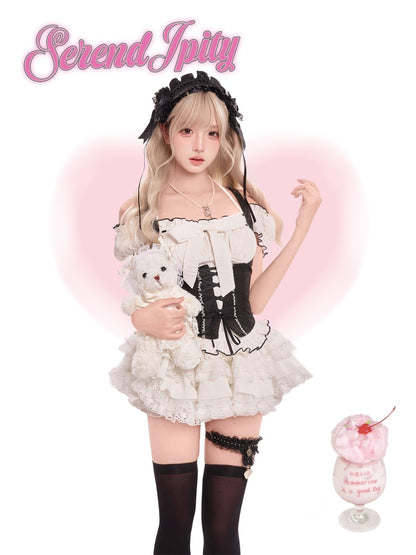 Person in a maid outfit holding a teddy bear