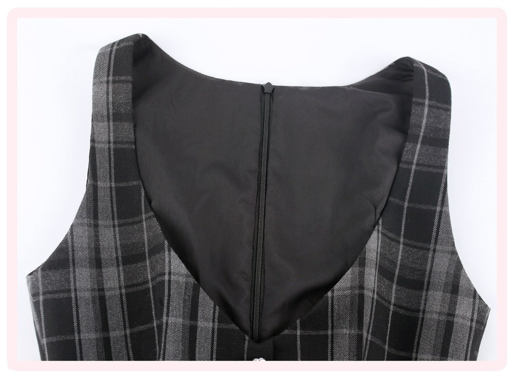 Close-up of the back of a sleeveless plaid vest or dress, showing a black center panel with a zipper and gray/black plaid fabric on the sides, set against a white background with a light pink border.