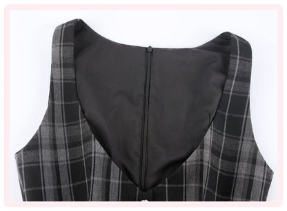 Close-up of the back of a sleeveless plaid vest or dress, showing a black center panel with a zipper and gray/black plaid fabric on the sides, set against a white background with a light pink border.
