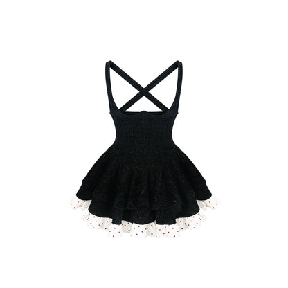 Black dress with criss-cross straps on a white background