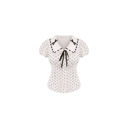 White blouse with black polka dots and bow details on a white background