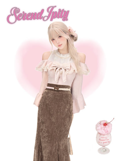 A young woman with long blonde hair models a pastel pink off-the-shoulder blouse with a large bow and a brown textured midi skirt, set against a white background with a pink heart and the text 'Serendipity' in the top left.