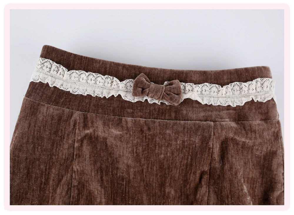 Brown velvet corduroy skirt featuring a decorative cream lace waistband with a matching fabric bow, shown against a light gray background.
