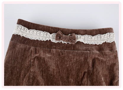 Brown velvet corduroy skirt featuring a decorative cream lace waistband with a matching fabric bow, shown against a light gray background.