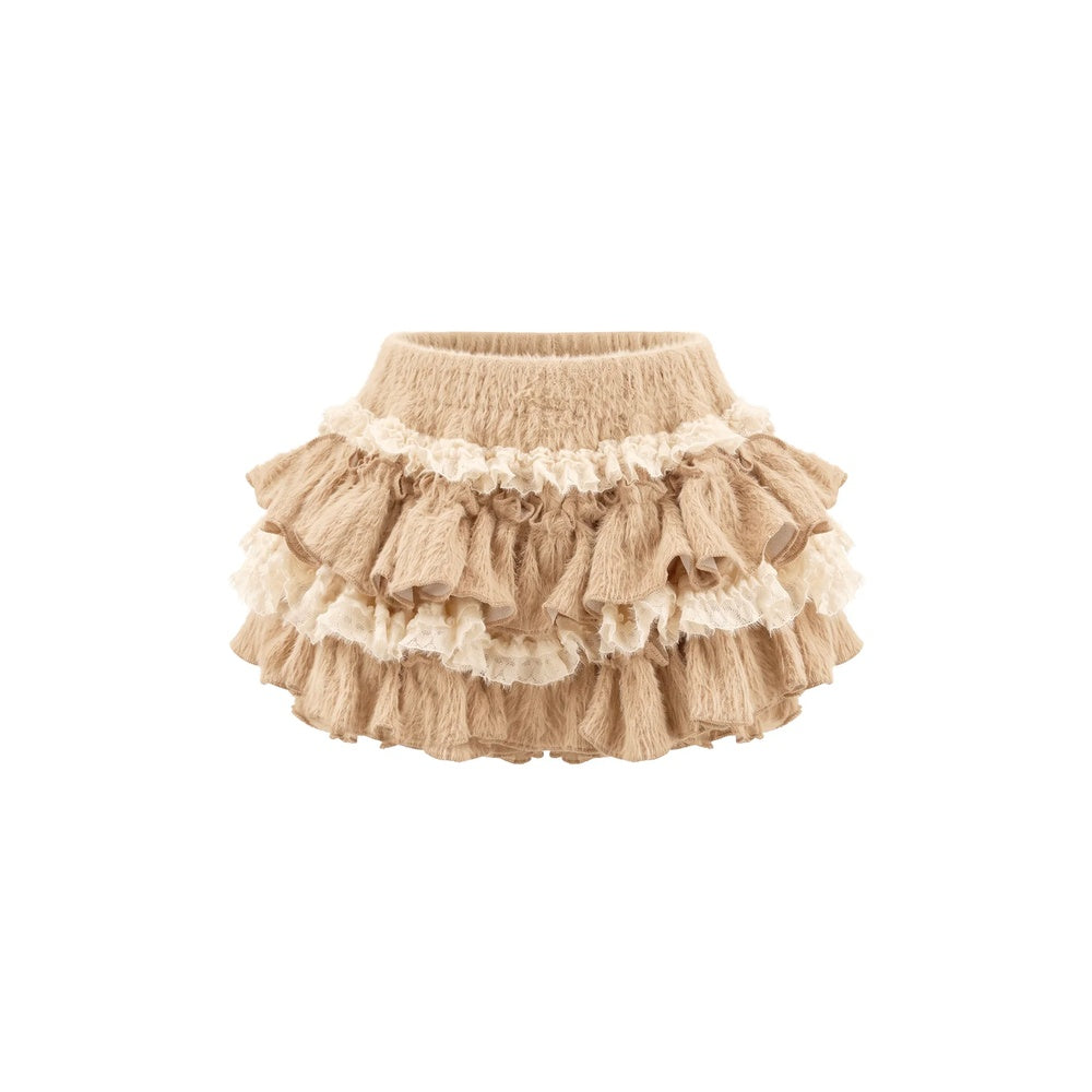 A beige ruffled baby skirt with multiple tiers and cream lace trim, shown against a plain white background.