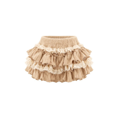 A beige ruffled baby skirt with multiple tiers and cream lace trim, shown against a plain white background.