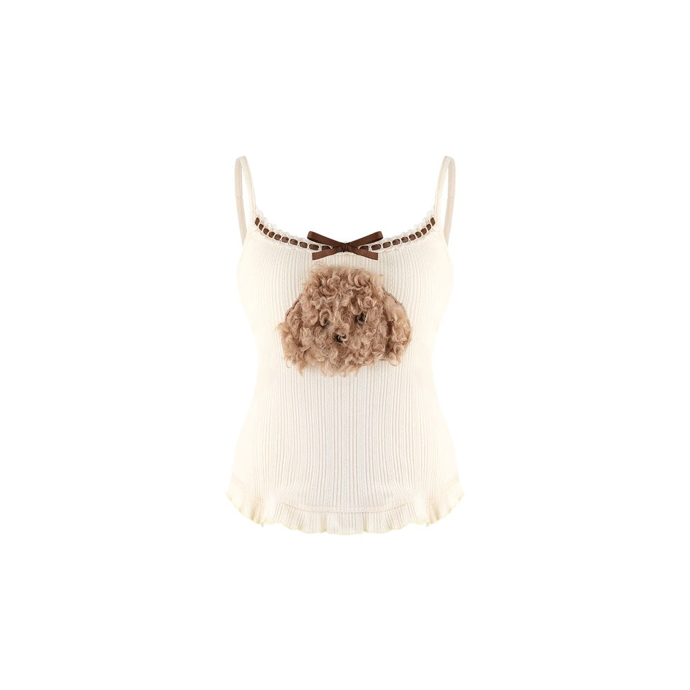 An off-white ribbed camisole top featuring a brown bow at the neckline, a decorative brown chain detail, and a 3D fluffy dog head embellishment on the chest.