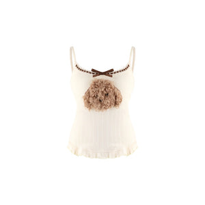 An off-white ribbed camisole top featuring a brown bow at the neckline, a decorative brown chain detail, and a 3D fluffy dog head embellishment on the chest.
