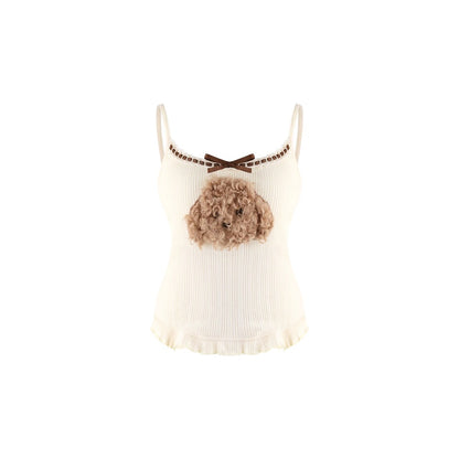 An off-white ribbed camisole top featuring a brown bow at the neckline, a decorative brown chain detail, and a 3D fluffy dog head embellishment on the chest.