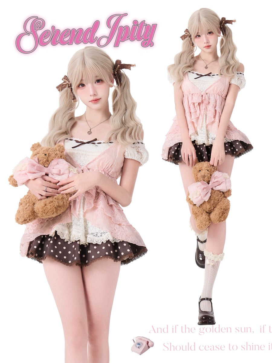Person in a cute outfit with a teddy bear, wearing a polka dot skirt and holding a bow.