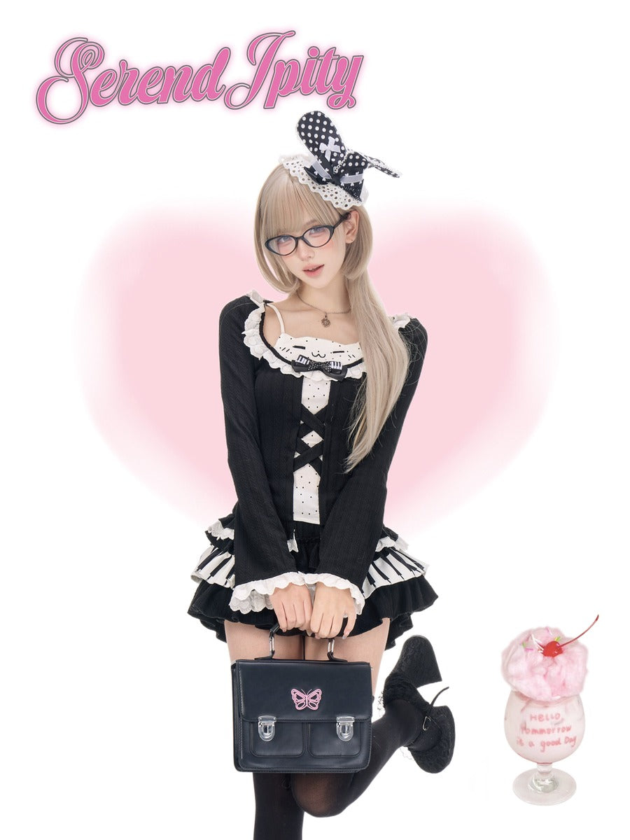 A woman modeling a black and white lolita-style dress with ruffles, holding a matching black handbag, against a white background with a pink heart graphic and the text 'Serendipity' at the top.