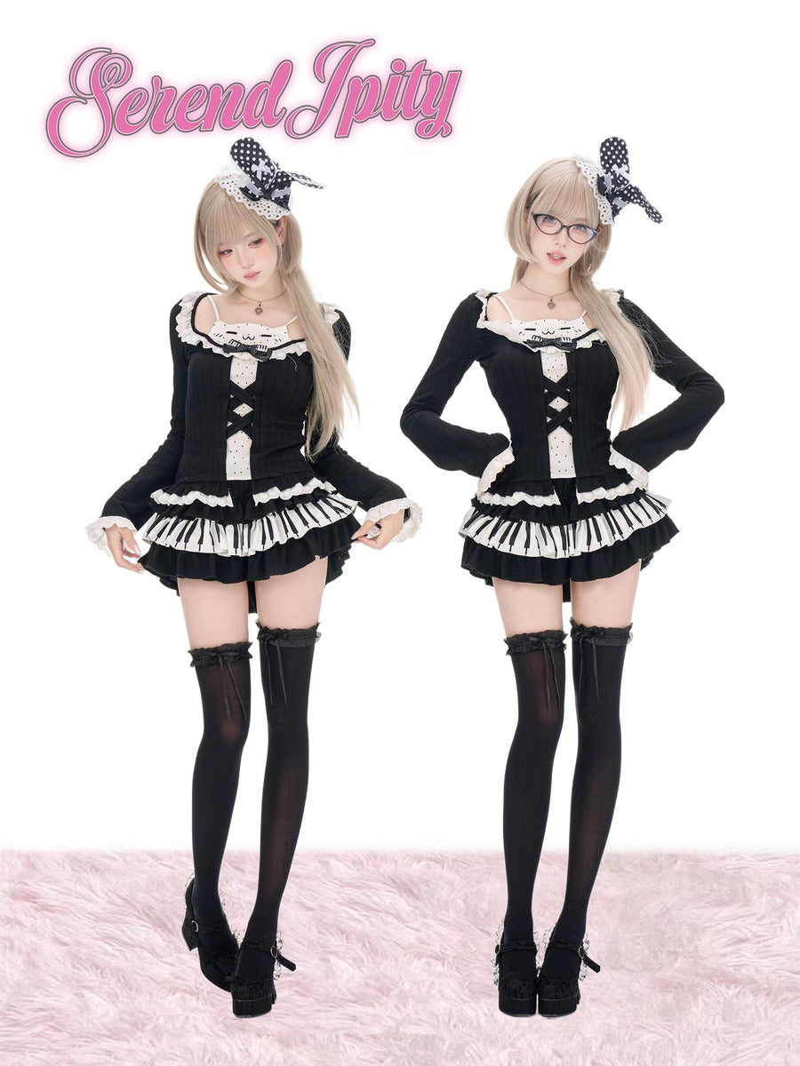 Two models wearing matching black and white Lolita-style outfits with black thigh-high stockings and black-and-white bow headbands, standing against a white background with a pink furry floor. The pink script logo 'Serendipity' appears at the top left.