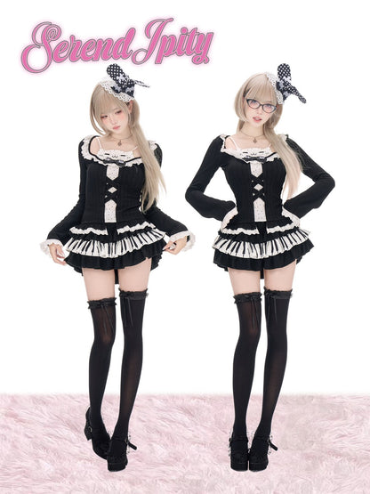 Two models wearing matching black and white Lolita-style outfits with black thigh-high stockings and black-and-white bow headbands, standing against a white background with a pink furry floor. The pink script logo 'Serendipity' appears at the top left.