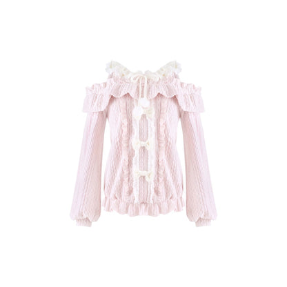 A light pink long-sleeve blouse with a textured knit body, ruffled collar, and white lace-up front details, shown against a plain white background.