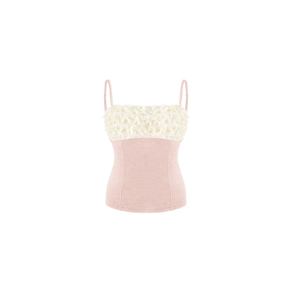 A light pink camisole top with a textured cream lace bust and thin shoulder straps, shown against a plain white background.