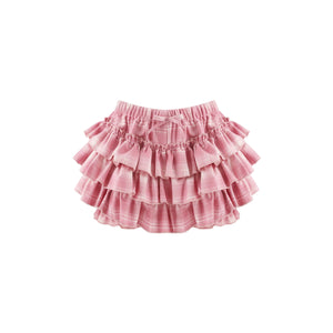 A pink tiered ruffle skirt with a subtle plaid pattern, featuring an elastic waistband and a small bow detail at the center front, shown against a plain white background.
