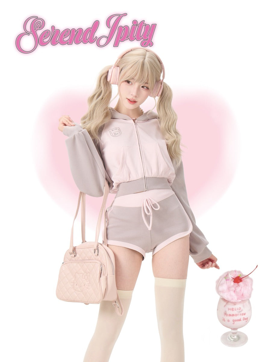 Person in pastel outfit, holding a pink handbag and a dessert.