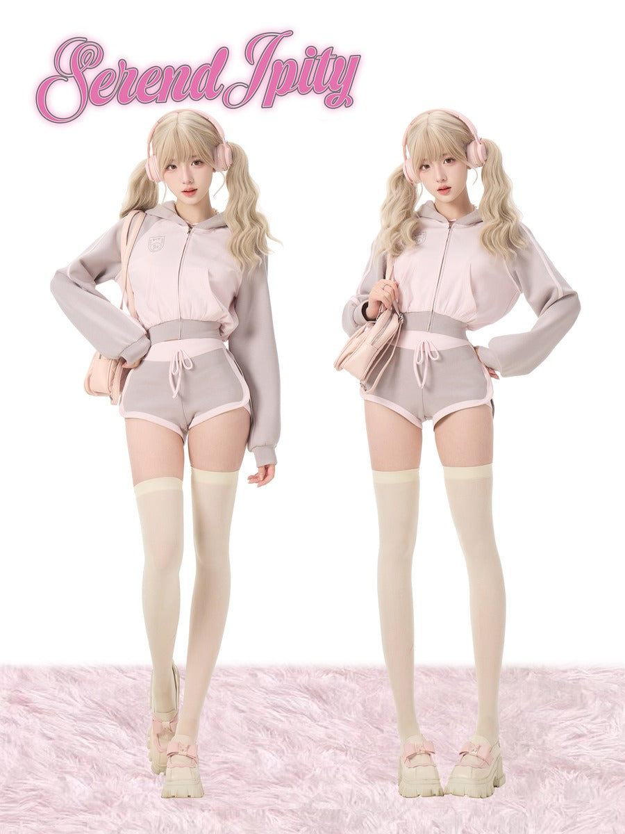 Two dolls in matching outfits on a pink background.
