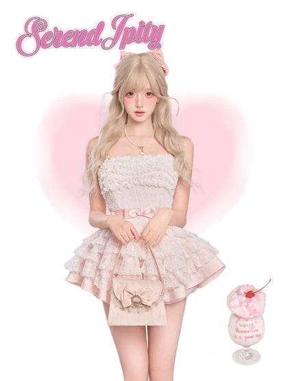 Woman in a pink lace dress with cat ears, holding a pink drink, on a white background.