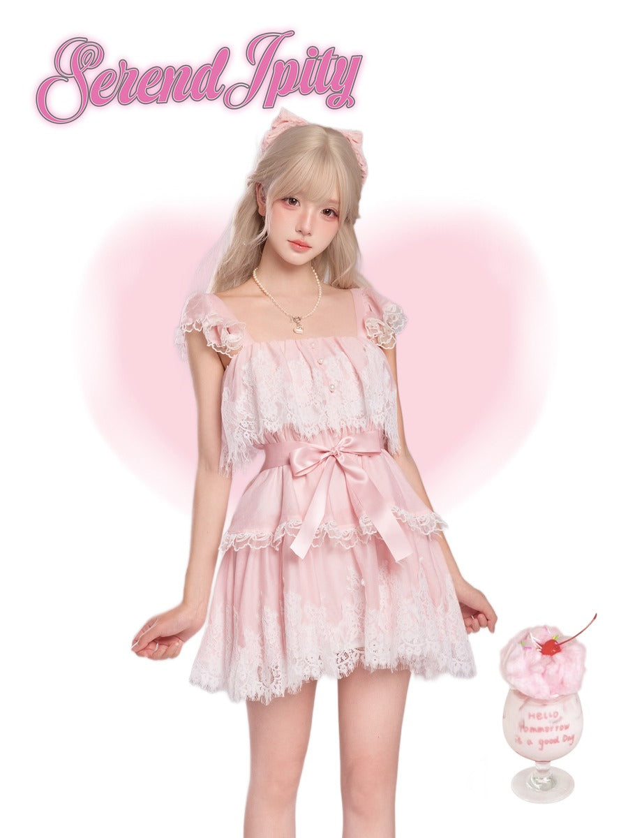 Person wearing a pink lace dress, holding a dessert.