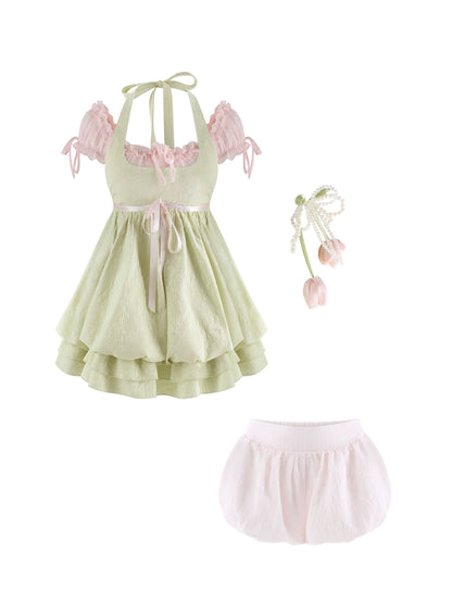 Pastel green dress with pink accents and matching bloomers on a white background