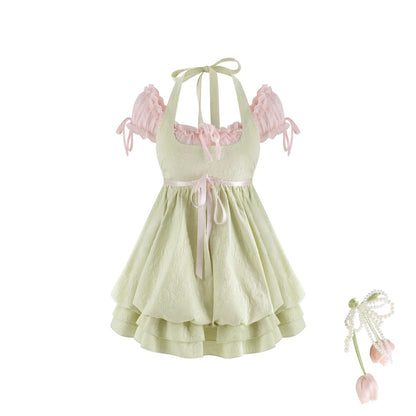 Light green dress with pink accents on a white background