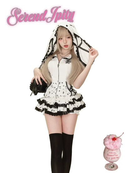 white hoodie with black edges, rabbit ears hood, and matching skirt