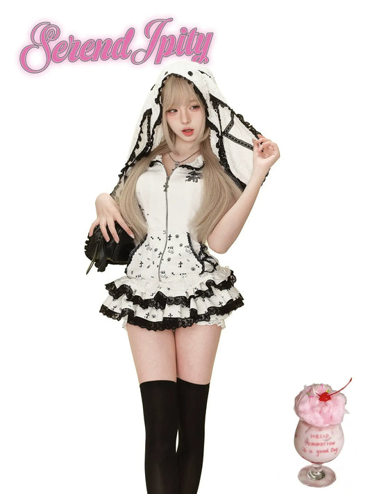 white hoodie with black edges, rabbit ears hood, and matching skirt