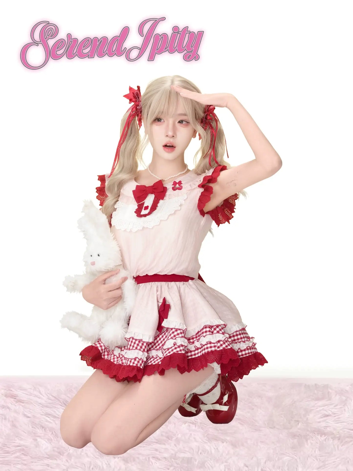 close-up of red‑pink strawberry dress fabric and white bloomers