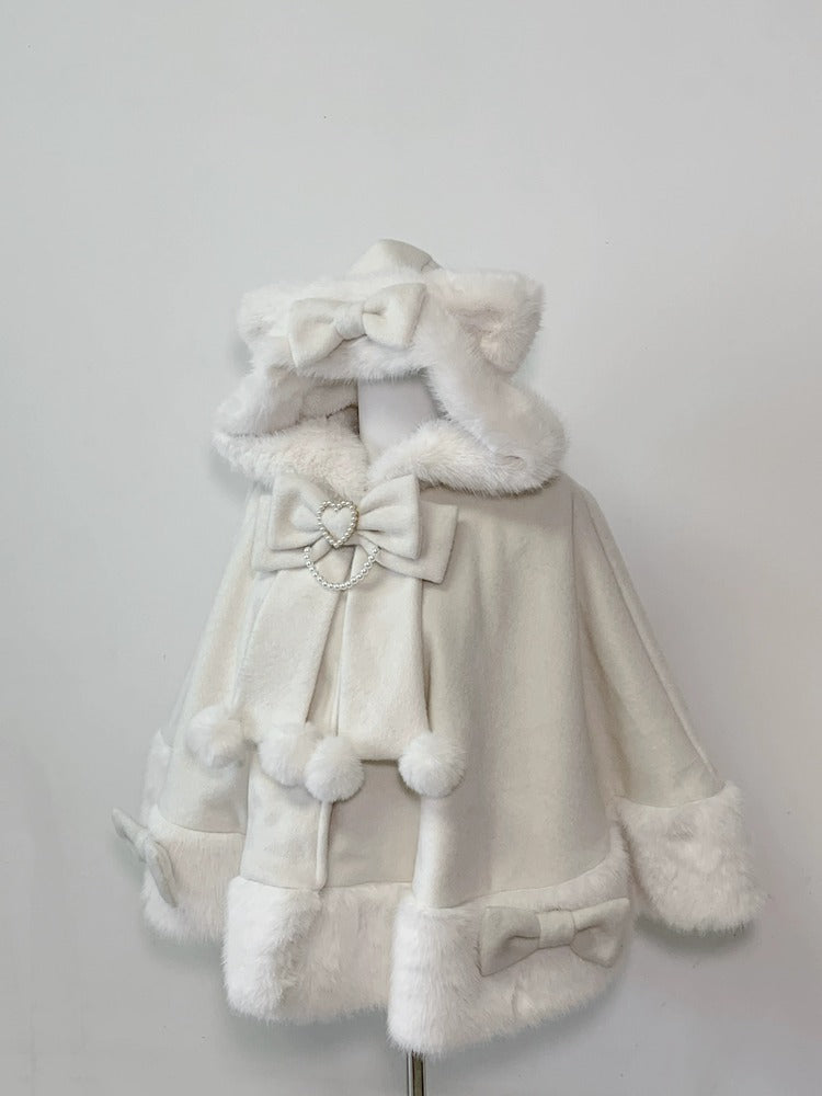 White fur coat with hood and decorative bows on a light gray background