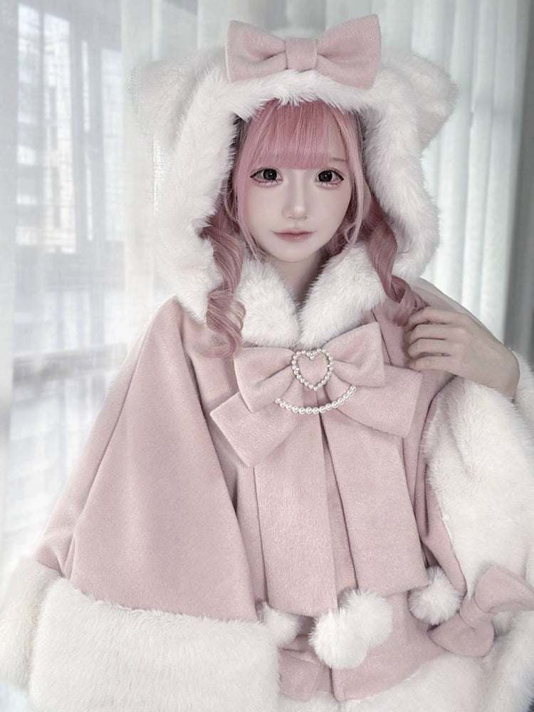 Person wearing a pink coat with large bows and white fur trim against a light background