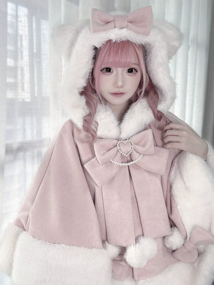 Person wearing a pink coat with large bows and white fur trim against a light background