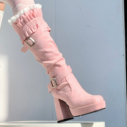 Pink knee-high boot with platform sole on a plain background