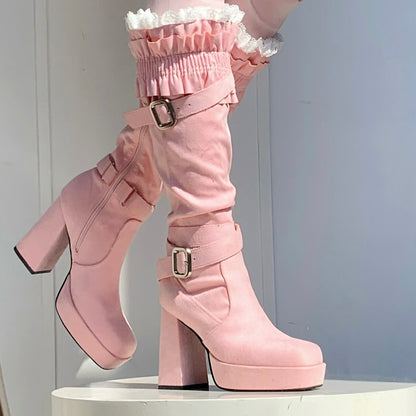 Pink platform boots with high heels on a white background