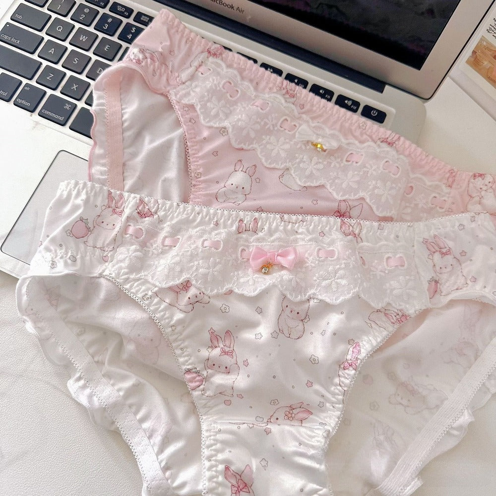Pair of pink and white patterned underwear on a laptop keyboard
