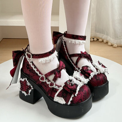 Red and black lace platform shoes with white bows worn indoors.