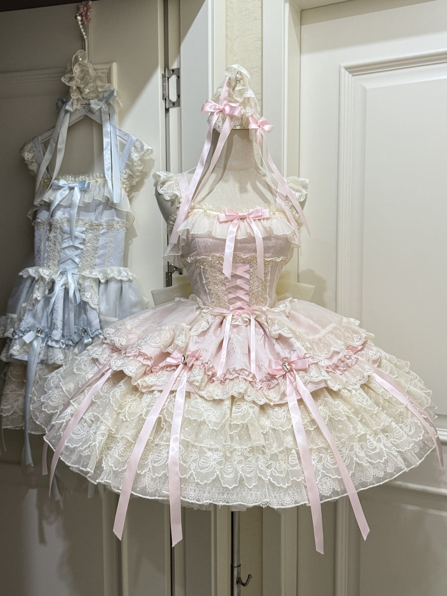 Two lolita lace dresses with ribbons on mannequins against a white door.