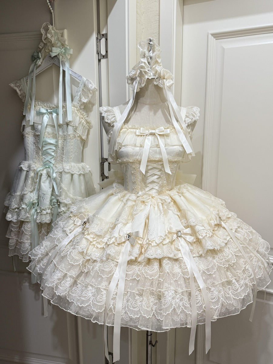 Two dresses on mannequins with intricate designs and ruffles in a neutral setting.
