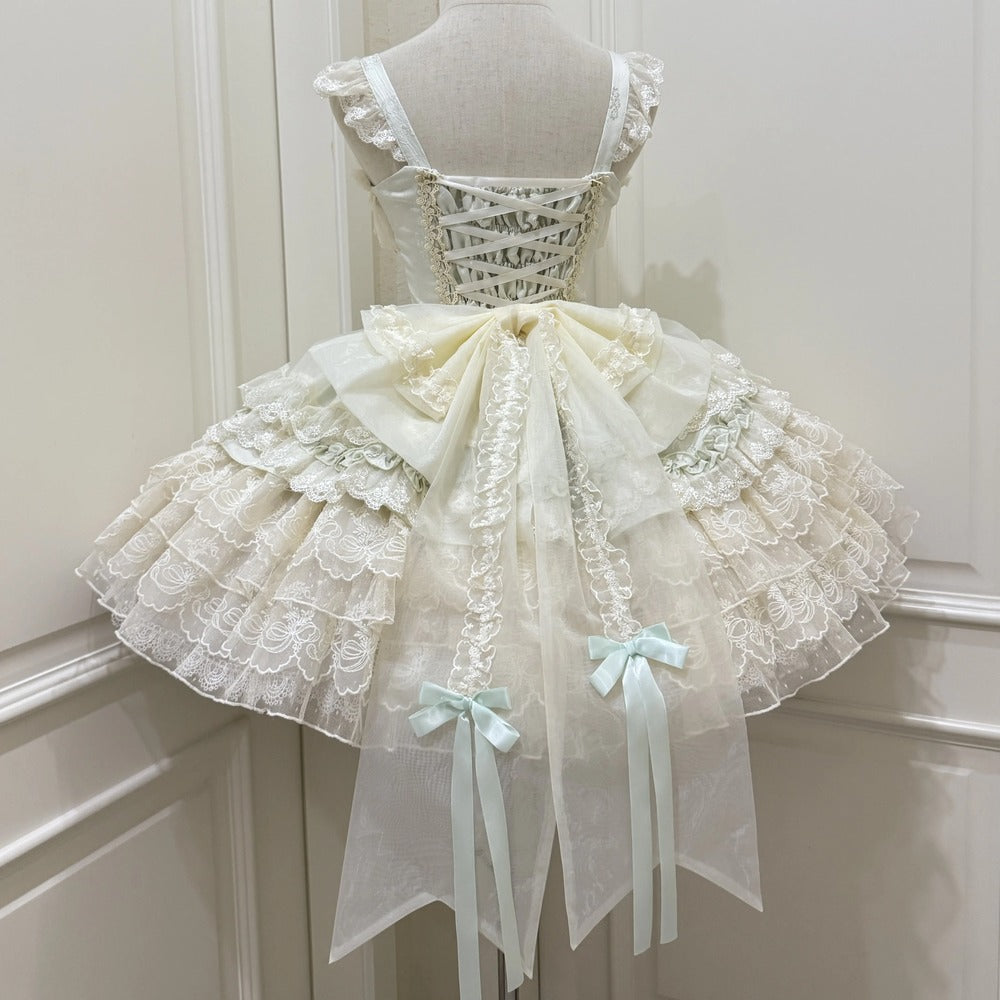 Delicate lace dress on a mannequin against a white wall