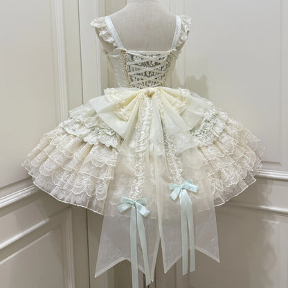 Delicate lace dress on a mannequin against a white wall