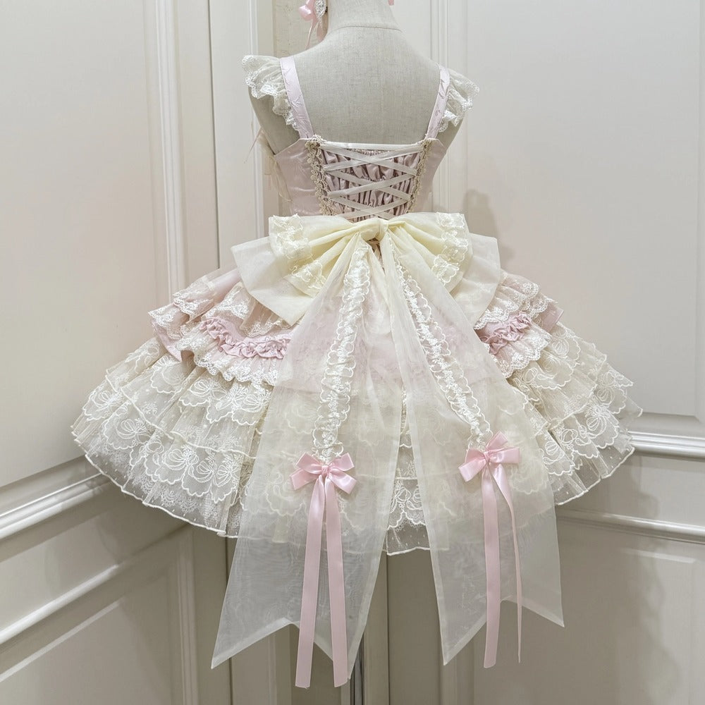 Delicate lace dress with pink ribbons on a mannequin against a white background