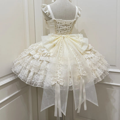 White lace dress on a mannequin against a white wall