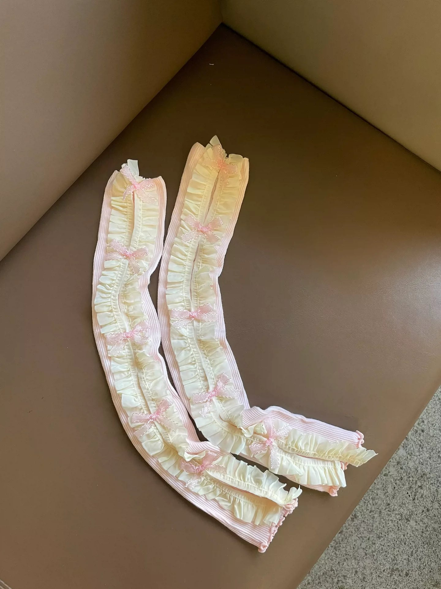 Floral-patterned arm warmers on a brown surface