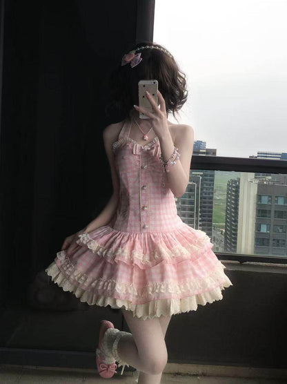 Person wearing a pink and white dress taking a mirror selfie.