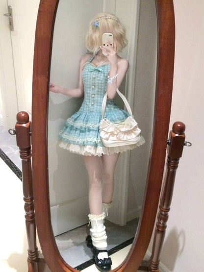 Person wearing a blue dress standing in front of a wooden-framed mirror.