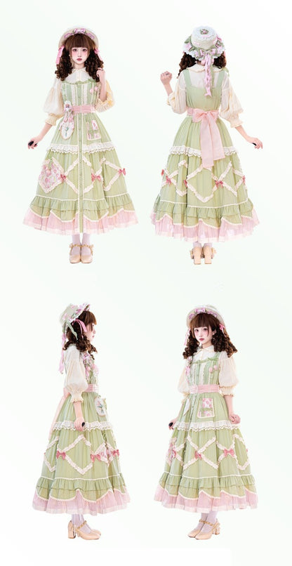 Green and pink dress with floral patterns worn by a model on a white background