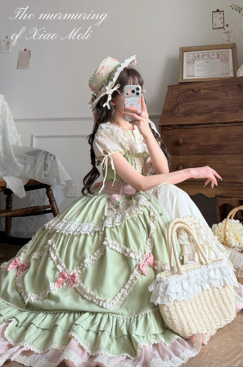 Woman in a green and white vintage-style dress holding a straw bag in a room with wooden furniture.